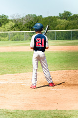 Teen baseball player at bat