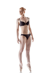 Attractive red-haired ballerina isolated on white