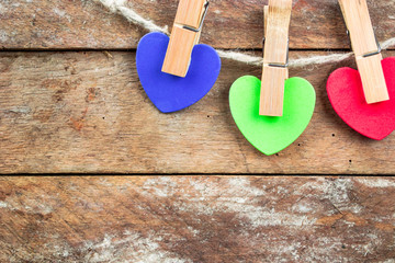  Colored hearts on wooden background