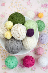 A lot of bright balls of knitting on the background