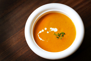 Carrot and yam creamy soup with cream and thyme, appetizer - 54188567
