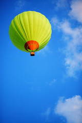 Green balloon in the sky.