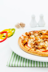 Delicious homemade pizza with ham and vegetables.