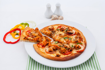 Delicious homemade pizza with ham and vegetables.