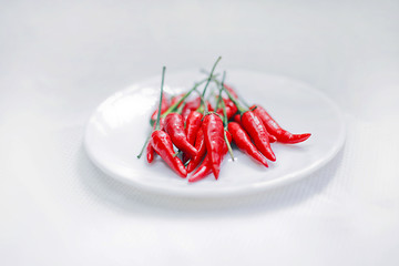 small red chillies on white plate