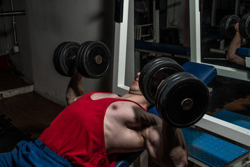 Fototapeta na wymiar young bodybuilder doing bench press for chest
