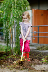 Little girl helping in a garden