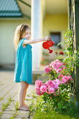 Cute little girl watering flowers © MNStudio