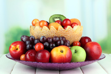Obraz na płótnie Canvas Assortment of juicy fruits on wooden table, on bright