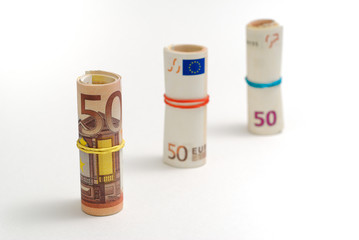 Three ascended vertical rolls of 50 euro bills