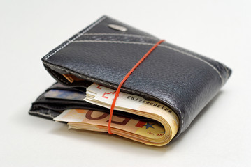 Black Wallet full with 50 euros isolated on a white background