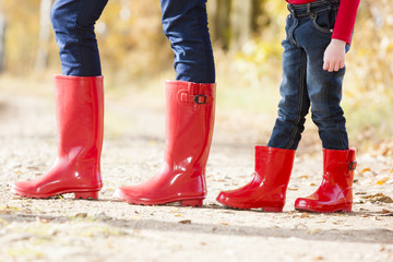 detail of mother and daughter wearing rubber boots