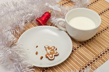 Obraz na płótnie Canvas Decorated Sugar Cookies and Milk for Santa at Christmas Time