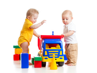 two little kids playing with color toys