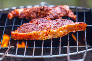 Flames grilling a steak on the BBQ