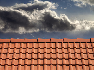 Roof tiles and storm sky