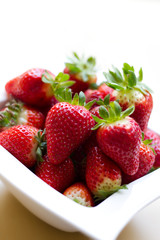 Red ripe strawberries in bowl closeup
