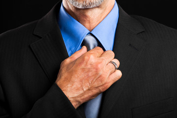 Businessman adjusting his tie