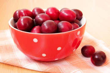 bowl of ripe plums close up