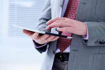 Male hands touching digital tablet