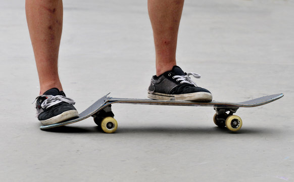 skateboarder with a broken skateboard