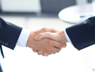 Closeup of a business hand shake between two colleagues
