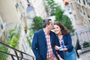 Fototapeta premium Beautiful couple on the stairs of Montmarte
