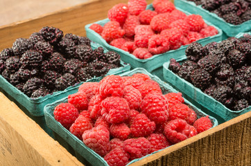 Wooden box with baskets of berries
