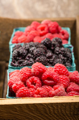Wooden box with baskets of berries