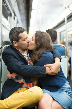 Couple kissing in the Parisian metro