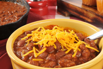 Bowl of chili with cheddar cheese