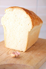 bread slice and garlic at wooden table