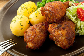 Roasted chicken legs with young potatoes