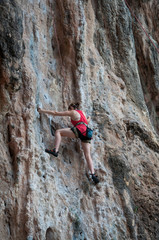 Woman climbing on the rock route summer (Railay Beach, Krabi pro