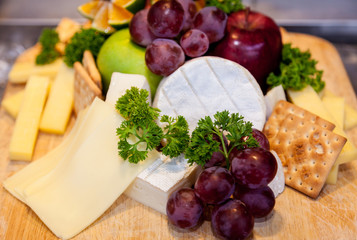 Various types of cheese and ripe grapes buffet.