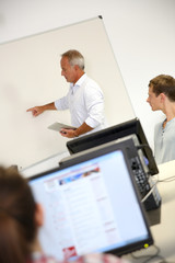 Fototapeta premium Business school teacher doing lecture on whiteboard