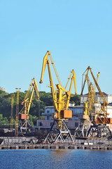 Fototapeta premium Port cargo crane over blue sky background