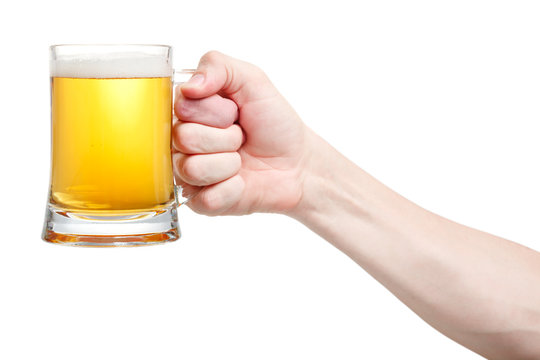 Closeup Of A Male Hand Holding Up A Glass Of Beer Over A White B