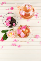 Kettle and cup of tea from tea rose