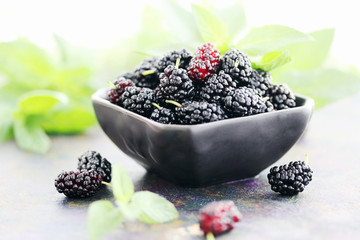 juicy mulberry on a black plate © Mallivan