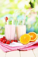 Delicious milk shakes with strawberries and orange