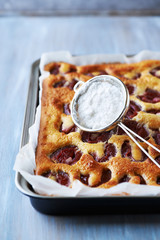 Homemade plum cake in a baking tin
