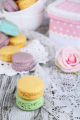 Macaroons in bowl on wooden table close-up