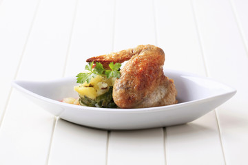 Roast chicken wing with potatoes