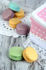 Fototapeta na wymiar Macaroons in bowl on wooden table close-up