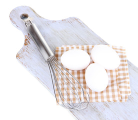 Corolla and eggs on wooden board isolated on white