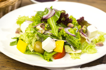 Greek salad on a white background in the restaurant