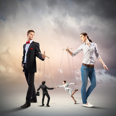 Businesspeople with marionettes