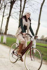 Fototapeta na wymiar Young woman on the bicycle