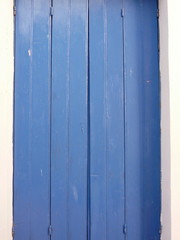 blue wood painted window shutter door in greece